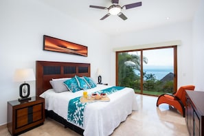 Breath-taking views follow you downstairs in the Master bedroom equipped with a king-sized bed.  
