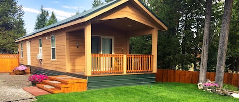 Front porch and exterior with parking space.