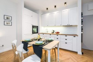 The sleek design of the kitchenette blending seamlessly with the living area.