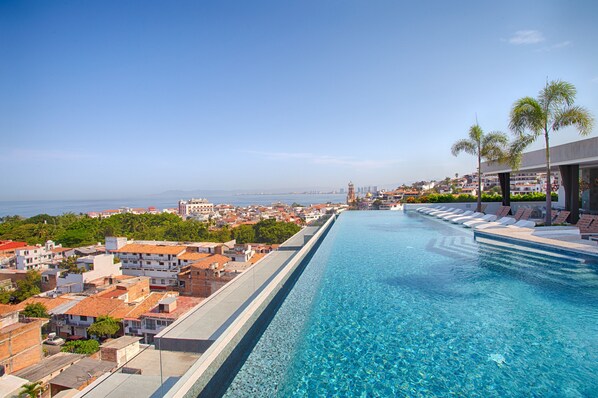 Infinity rooftop pool with city and mountain views