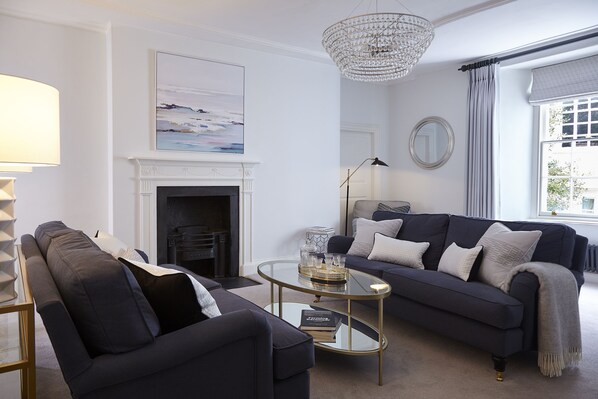 unwind in the elegant living room with its bespoke soft furnishings