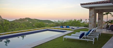 Pool with ocean view during sunset