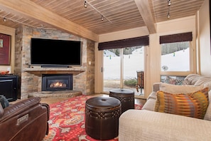 Living area with large windows and sliding door to the slopes. 60" Flatscreen TV