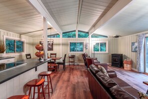 This is the 2nd floor open design kitchen, dining and living area with a flat screen tv, walk out deck and wood pellet stove. 