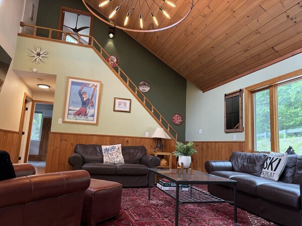 Relax by the wood burning wood stove and watch the 75 inch Roku TV.