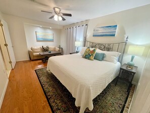 King bedroom 3 with seating area and doors leading to back deck