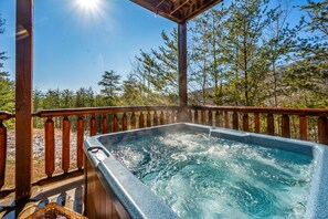 Relax in the hot tub under the twinkling string lights, with long-range views