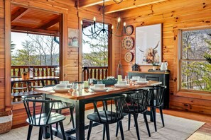 Rustic dining with modern chairs seats 8-10 guests.