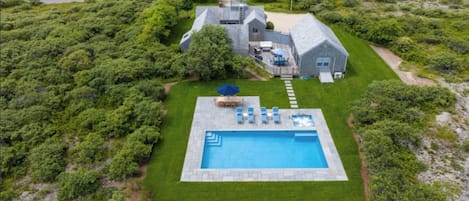 Aerial view of house, property and heated saltwater pool with spa