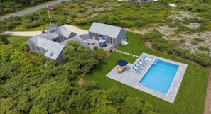 Aerial view of house, property and heated saltwater pool with spa