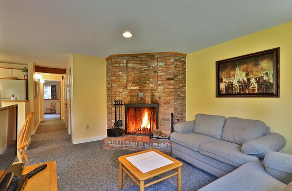 Our cozy one bedroom condo features a homey living area with wood burning fireplace.