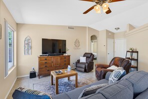 Living room view with Roku TV and recliners