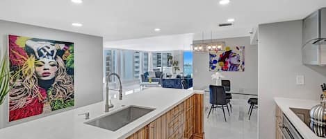 Fully equipped kitchen with washer/dryer, dining area, living room