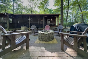 Wood Adirondack chairs around the firepit.