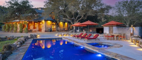 Pool at twilight with pool lights on.