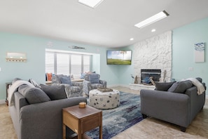 Family Time – Dolphin Cove’s living room is spacious and relaxing, with comfy seating, HDTV, fireplace and lots of light.