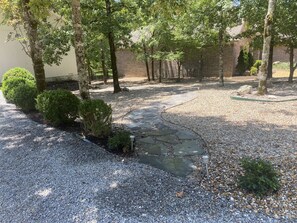 Follow path off driveway to apartment (parking above on gray rocks)