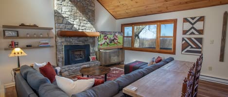 Living Room with Stone Fireplace, TV, and Long-Range View