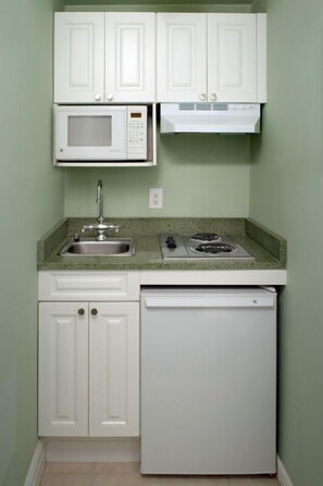 Kitchenette with coffee maker, mini-fridge, microwave, and stovetop