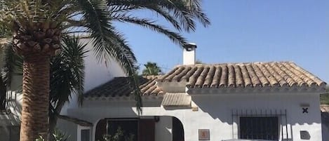 Front of bungalow with off road parking, and lemon/lime trees