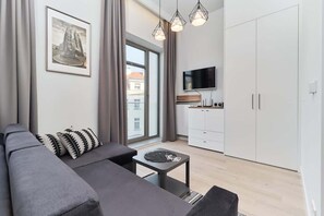 The elegant living area featuring a double sofa bed and coffee table.