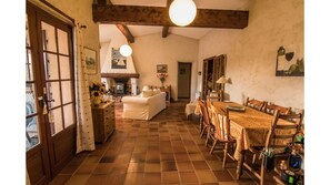 Lounge and dining area with 2 sets of french doors leading to the garden