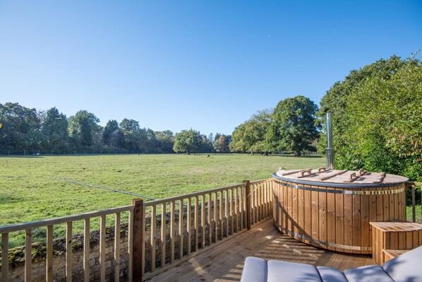 The Stable Cottage: The wood fired hot tub looking over the fields