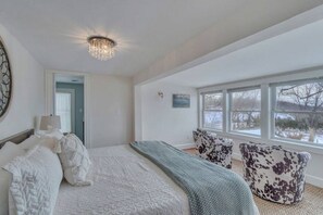 Master bedroom (King bed) and sitting area overlooking the pool and gardens