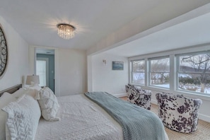 Master bedroom (King bed) and sitting area overlooking the pool and gardens