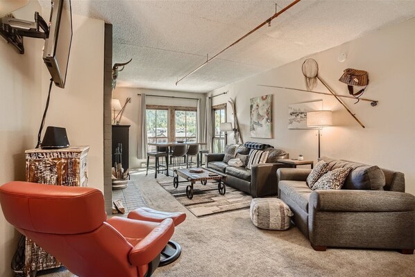 Living space with sofa sleeper, TV, and fireplace