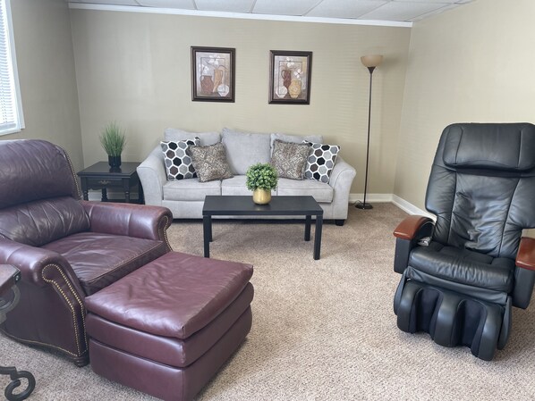 Spacious living room with relaxing massage chair. Smart TV with free Wifi.