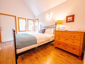 Master bedroom with a beautiful metal bed frame and hotel-quality bedding.