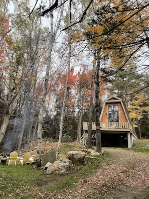 A-Frame in the trees. Long driveway, fire pit. Deck with picnic table and grill.