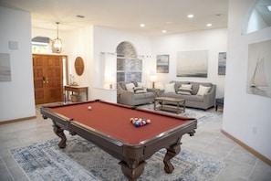 Living room and game room with pool table and 65" tv