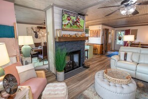 Open Concept Main Level, anchored by Central Gas Log Fireplace with Reclaimed Wood Mantle