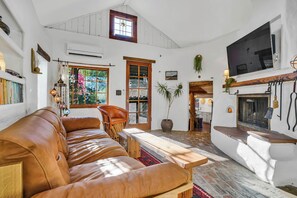 Cozy and bright living room with TV, DVDS, games, and books.