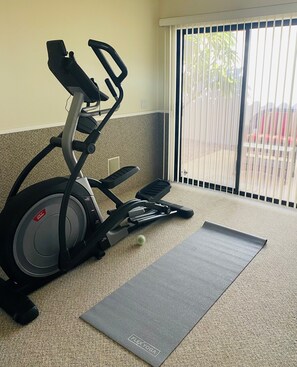 TV Elliptical and weights in room adjacent to Master bathroom

