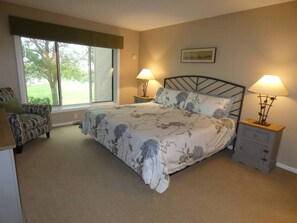 Master bedroom with king bed, tv, and ensuite bathroom.