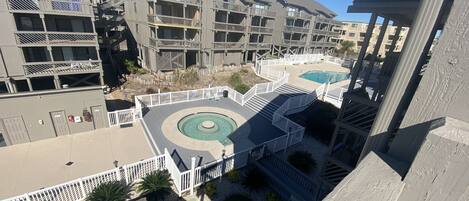 View of pool area, hot tub, propane grills