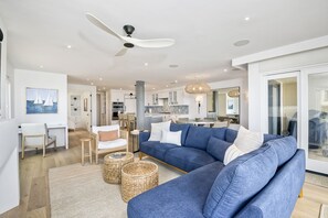 Open concept living/dining/kitchen with a contemporary-coastal design
