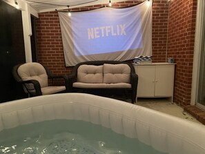 Screened in porch with projector screen for movie nights!