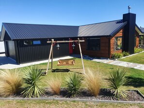 Front of house and garden area with our custom made swing chair 