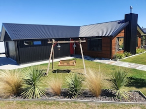 Front of house and garden area with our custom made swing chair