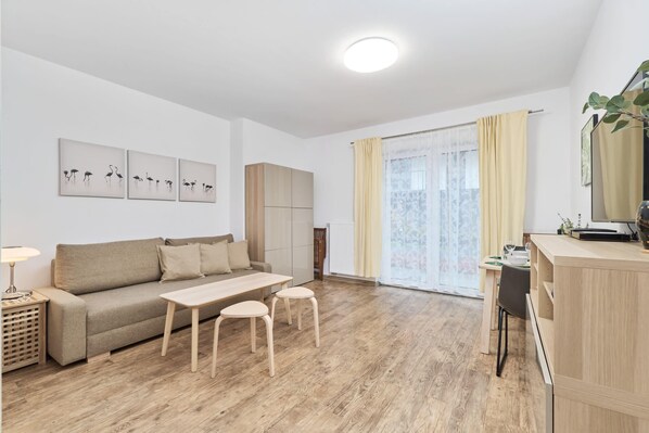 Relax in the stylish living area with a comfortable sofa and modern decor.