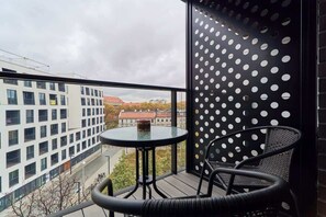 The balcony's stylish design complements the apartment's decor. 