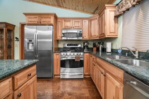 Stainless steel appliances. Fully functional open kitchen.