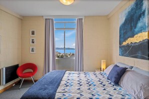 The primary bedroom offers a queen bed with stunning views, ensuring a restful night's sleep. Wake up refreshed and take in the picturesque scenery from the comfort of your bed.