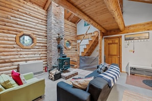 living room with overhead cat walk leading to two upstairs bedrooms