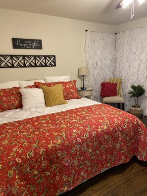 Red Room features king size bed, dresser, nightstand, alarm/charger with chair