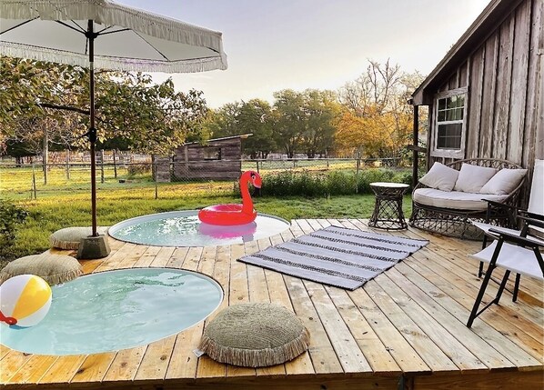 Cowboy pools with lots of deck space with the larger pool heated in the cold.